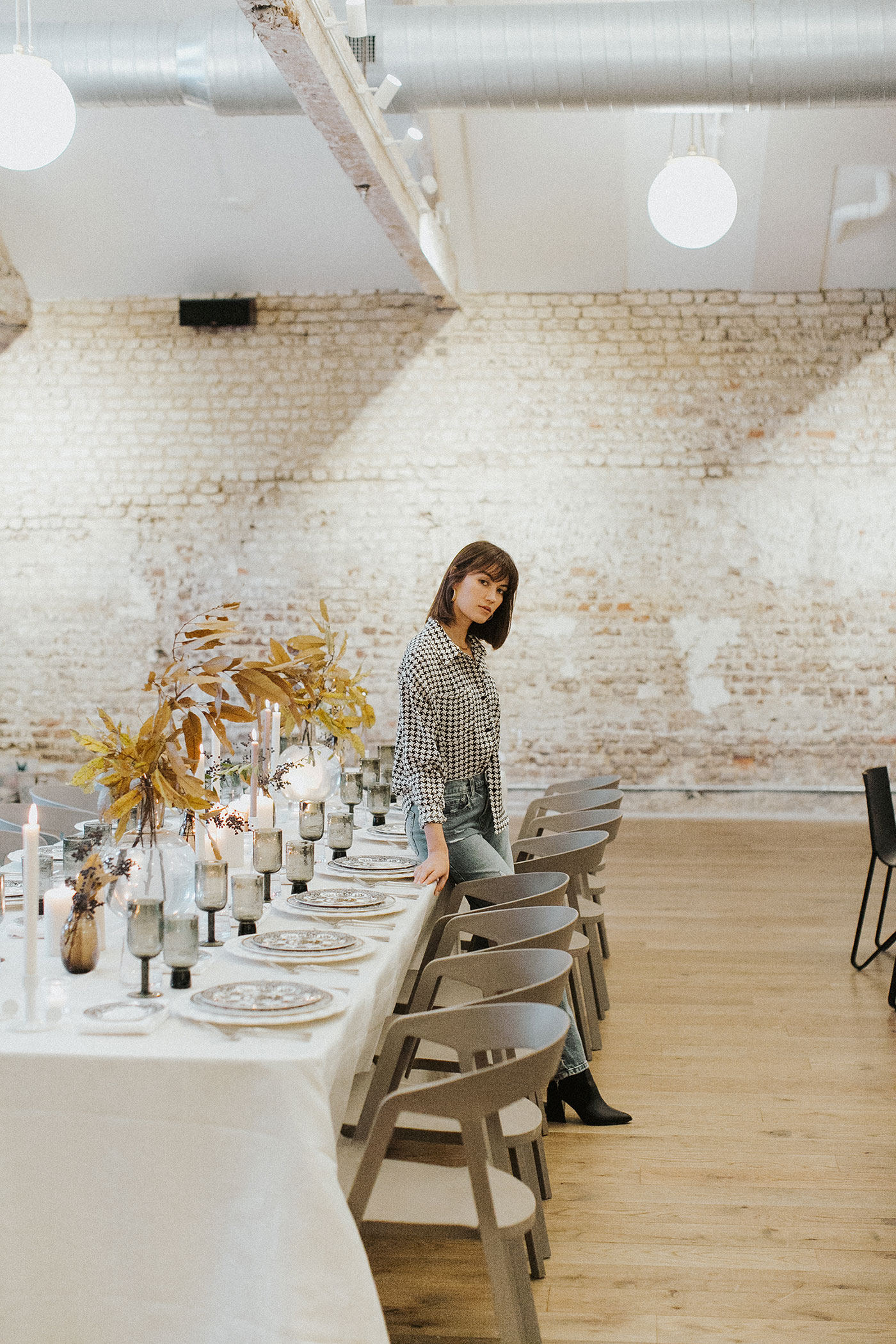 Woman sitting on family-style table in banquet hall