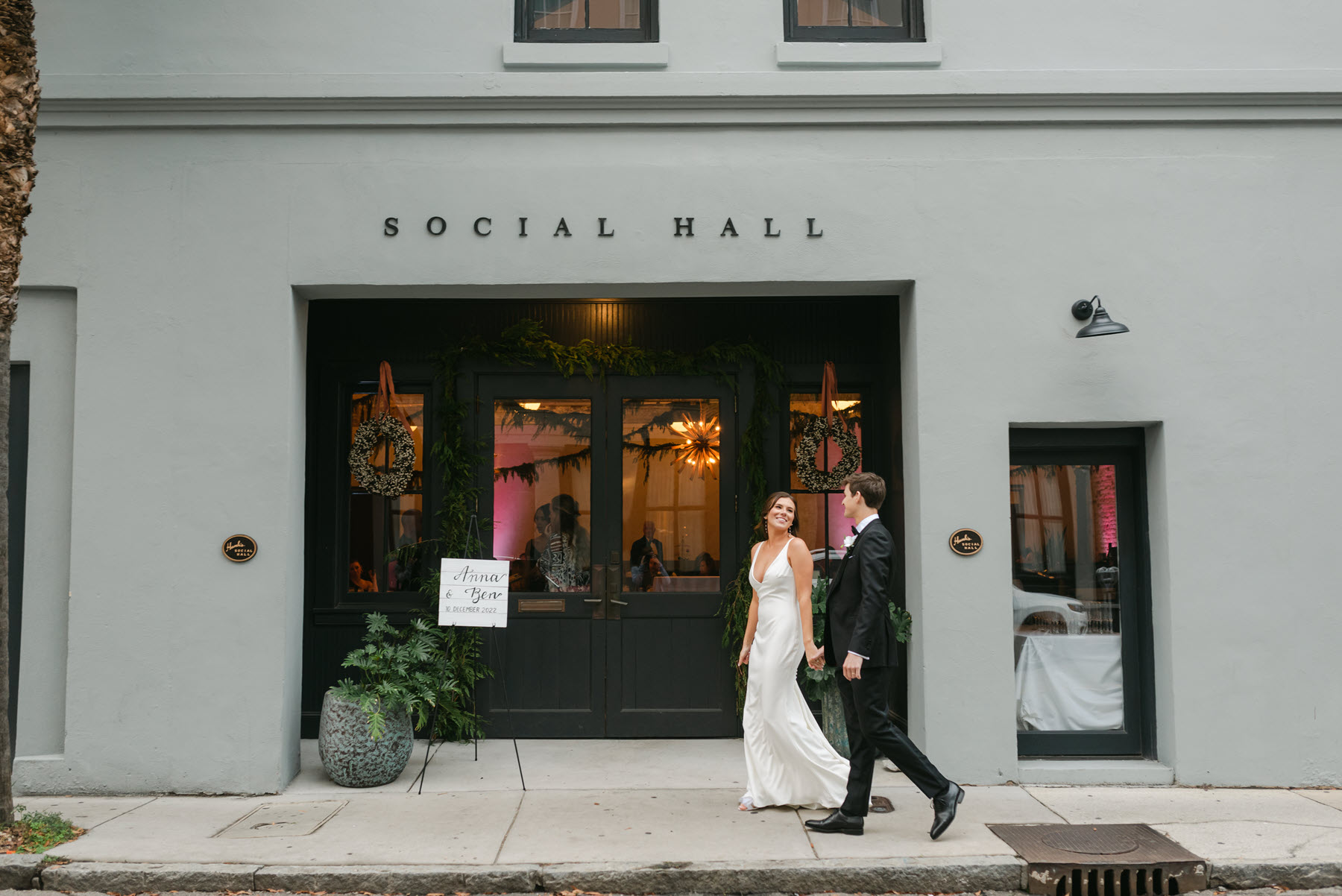 bride and groom walking to entrance of Hanks Social Hall