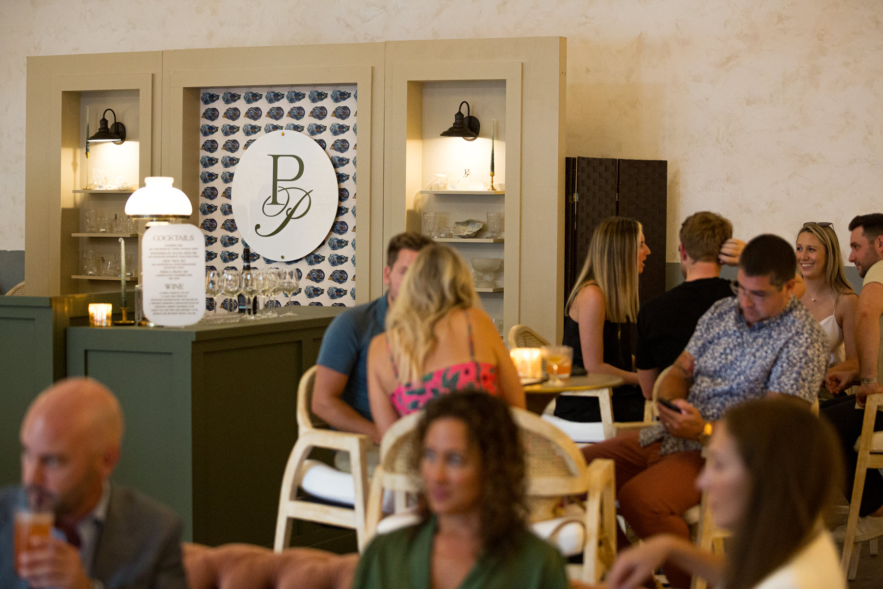 people seated in a dining area with perky pearl sign in background